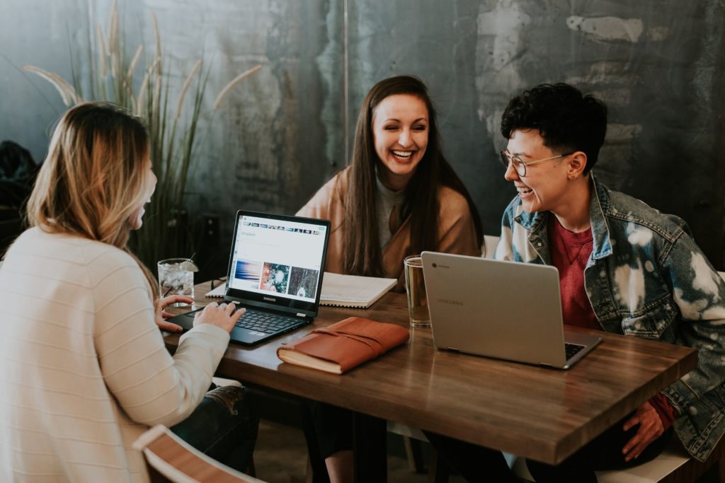 group of writers smiling and working together