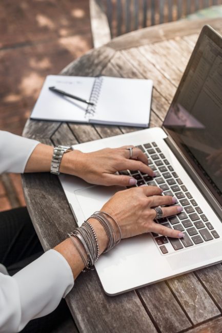 women hands typing on laptop