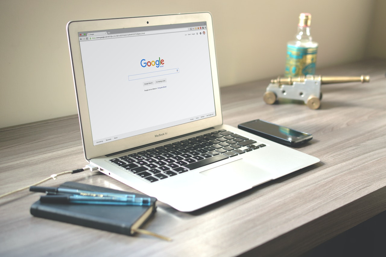 laptop on desk with google's search engine pulled up