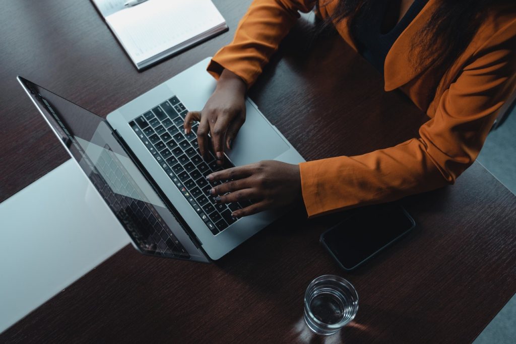 person typing on a laptop