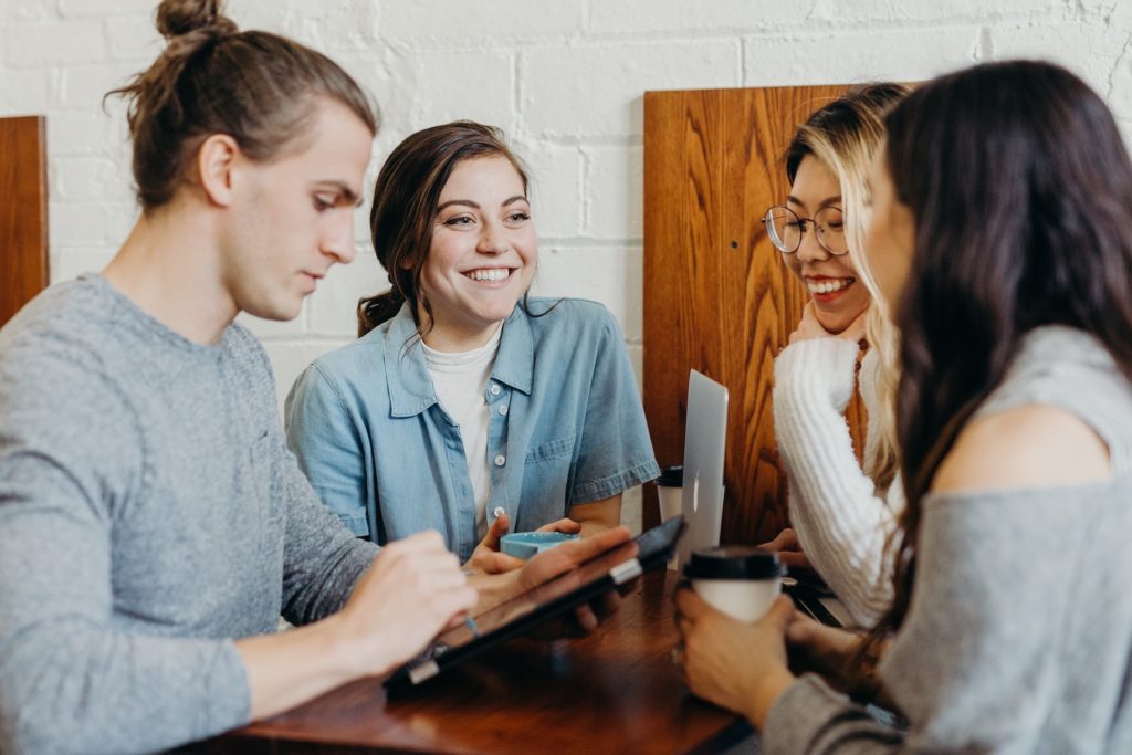 group of people in an office smiling and working