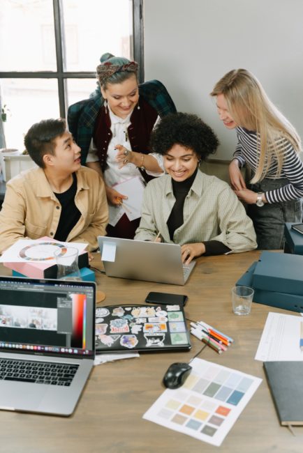 group of people working and smiling in office